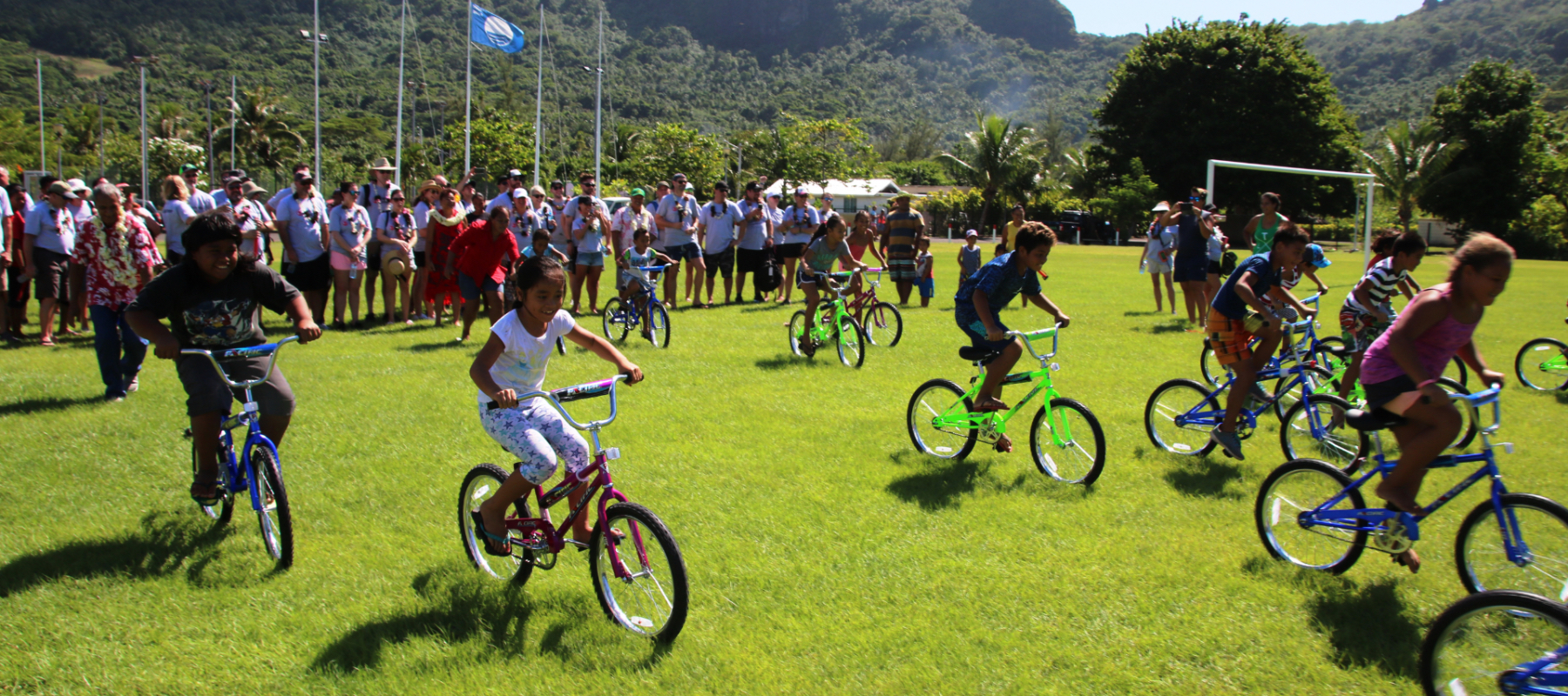 Image of a group of children riding bikes in a field